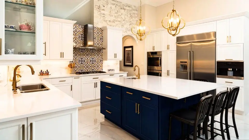 Modern kitchen renovation featuring a blue island, white cabinetry, and gold accents – Mr. Does All Tampa Bay.